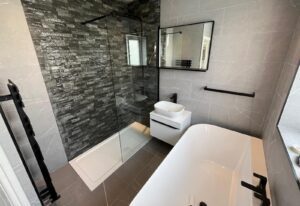 Bathroom with walk-in shower, freestanding bath and wall-hung vanity unit